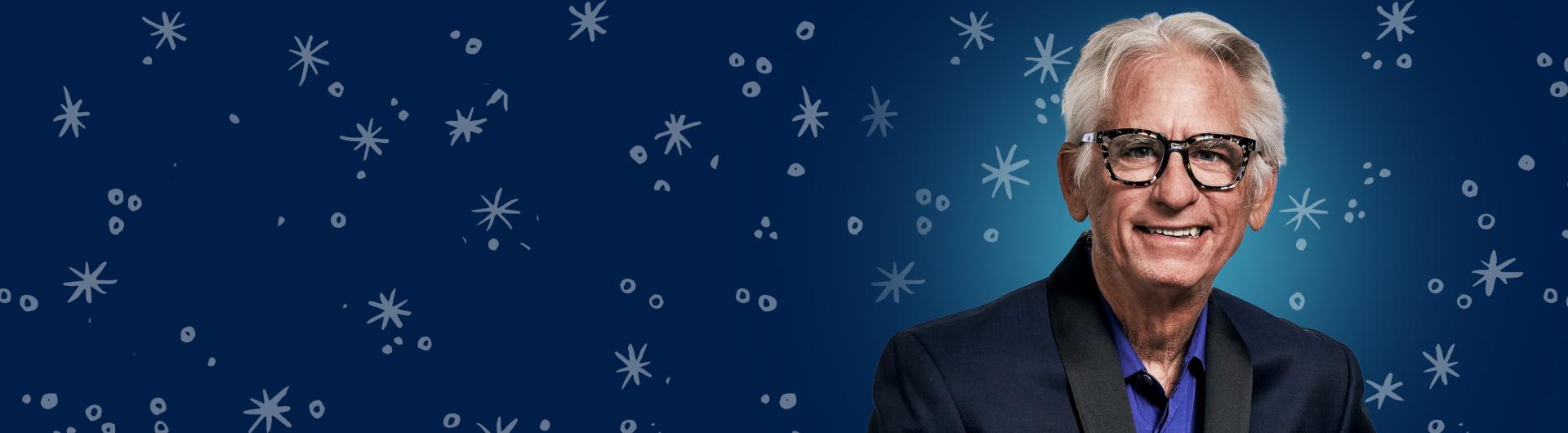 David Benoit standing in front of a background of winter snowflakes