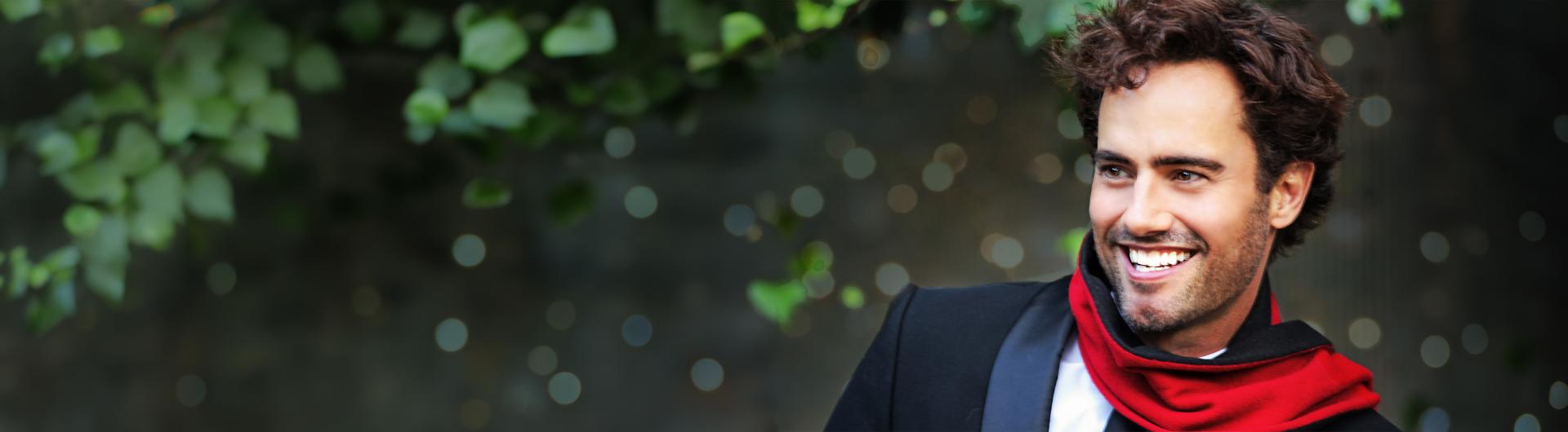 David Burnham against a background of blurred holiday lights