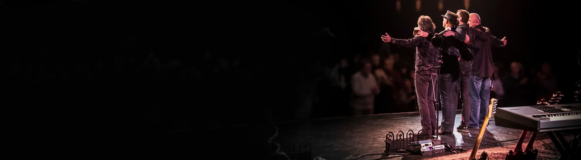 Members of Hotel California on stage, facing the audience.