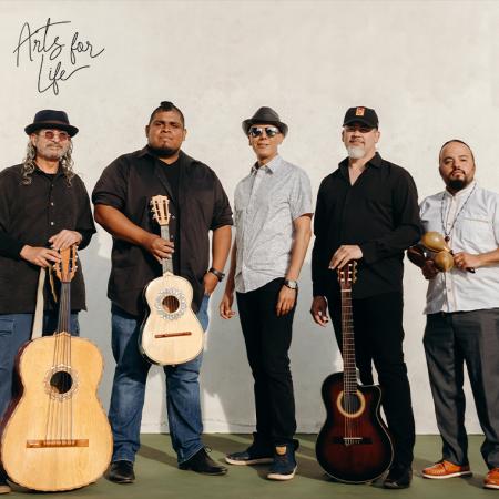 Members of Jarabe Mexicano posing with their stringed instruments.