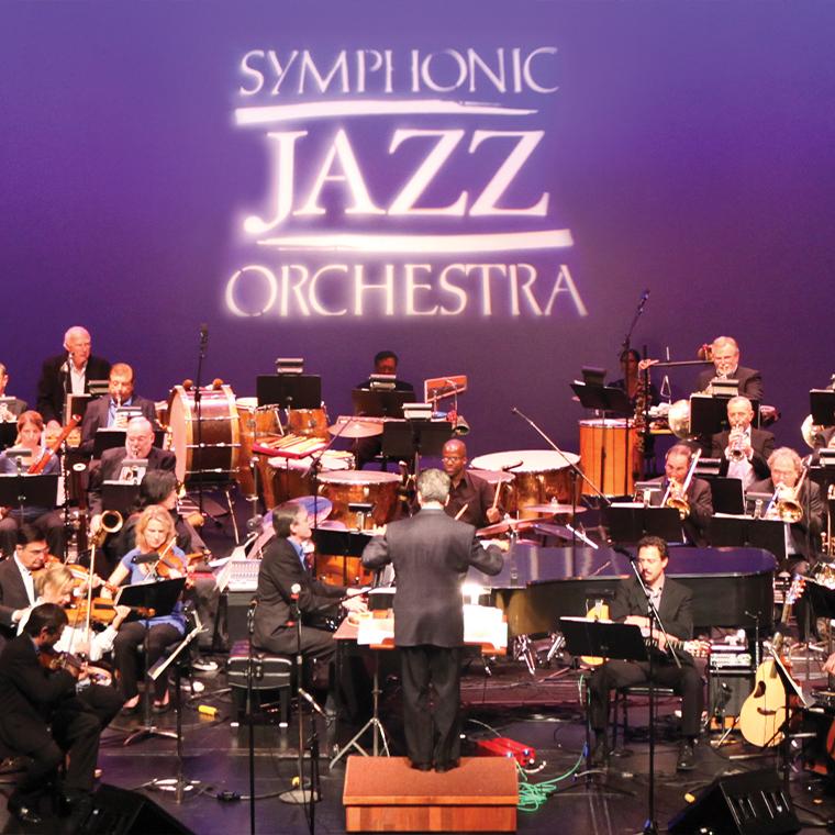 SJO performing on the Carpenter Center stage with their logo projected behind them.